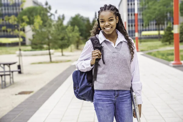 Cute black teenager university student on campus with backpack — Stockfoto