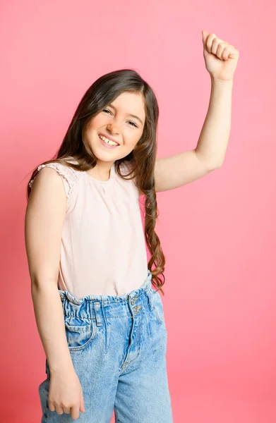 Cute child over pink backgroud on studio with hand up — ストック写真