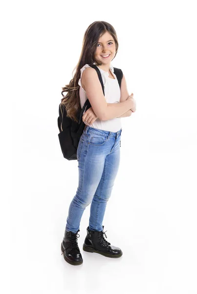 Cute smiling schoolgirl in uniform standing on white background with agenda — Stock Photo, Image