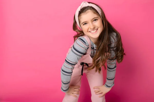 Cute child with dungarees over pink background on studio — Stock Fotó