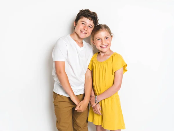 Portrait of cute girl and boy on studio white background — Stockfoto