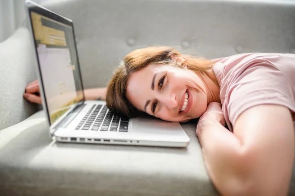 Vrouw ontspannen thuis op bank, genieten van vrije tijd met laptop op de bank — Stockfoto