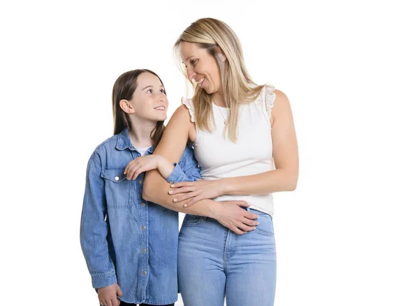 Beautiful pre teen girl with mother on studio white background — Stockfoto