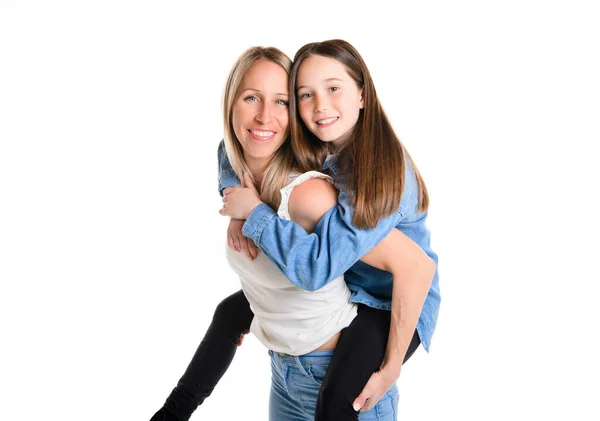 Beautiful pre teen girl with mother on studio white background — стоковое фото