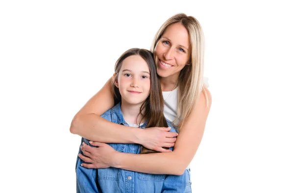 Beautiful pre teen girl with mother on studio white background — стоковое фото