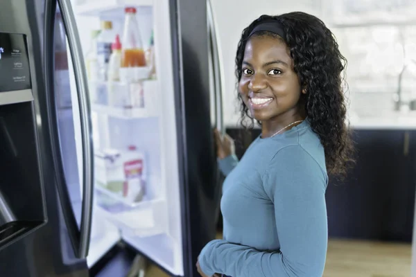 Young Woman on front of Fridge At Kitchen — Fotografia de Stock