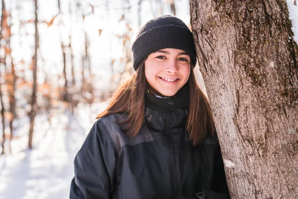 Portrait of happy little girl in winter forest — стоковое фото