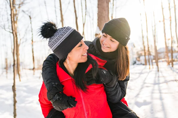 Portrait of mother with his teen girl while enjoying outdoors in winter — Stock Photo, Image