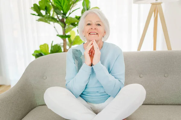 Portrait of elderly woman sit on the sofa at home — Stok fotoğraf