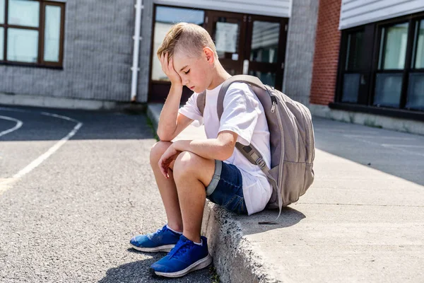 Very sad boy bullying in school playground. — стоковое фото