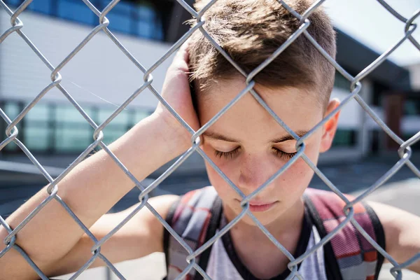 Very sad boy bullying in school playground. — Stock fotografie