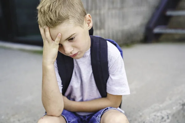 Very sad boy bullying in school playground. — стоковое фото