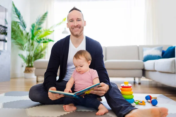 A happy man with baby reading book — Fotografia de Stock