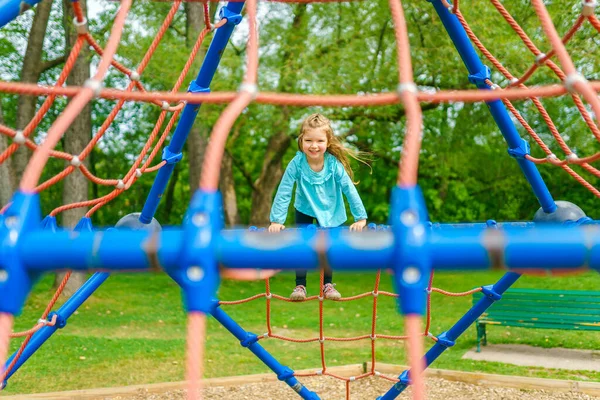 Happy little girl is playground having fun — Photo