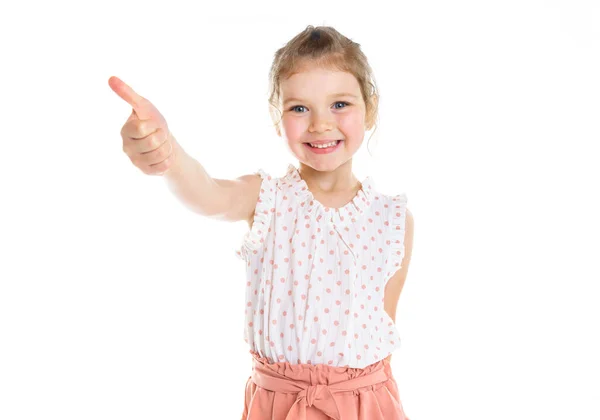 Cute five year old girl with thumb up on isolated white. — Stockfoto