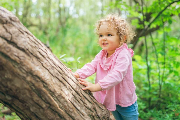 Little girl on tree in the summer on nature little girl — Stock Photo, Image