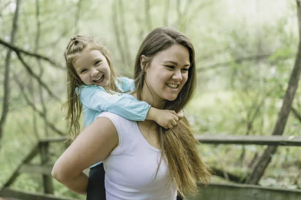 Nice mother having fun in summer forest with his child girl — Stock Photo, Image