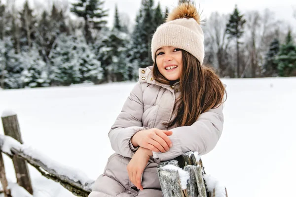 Beautiful child girl outdoors in winter. Snowing. Winter atmosphere — Stock Photo, Image