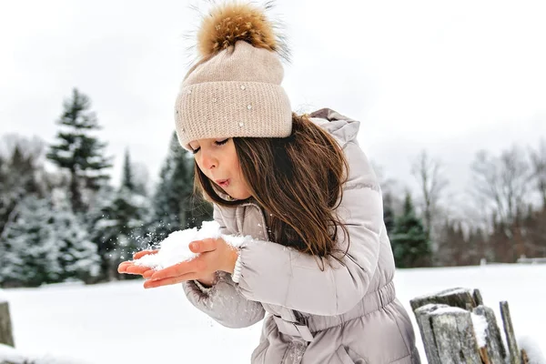 Beautiful child girl outdoors in winter. Snowing. Winter atmosphere — Stock Photo, Image