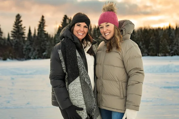 Beautiful girls friends are in the winter forest — Stock Photo, Image