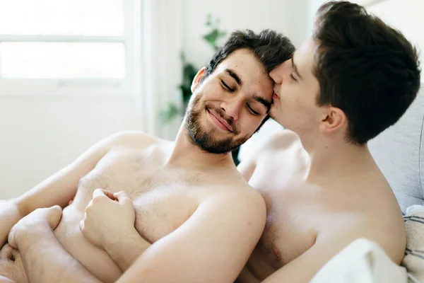 Homosexual couple under a bed at home — Stok fotoğraf
