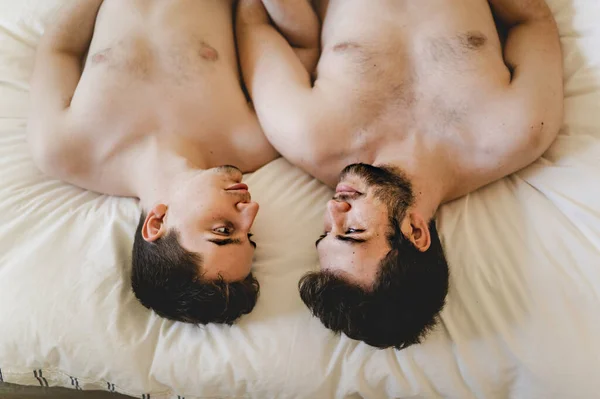 Homosexual couple under a bed at home — Foto Stock