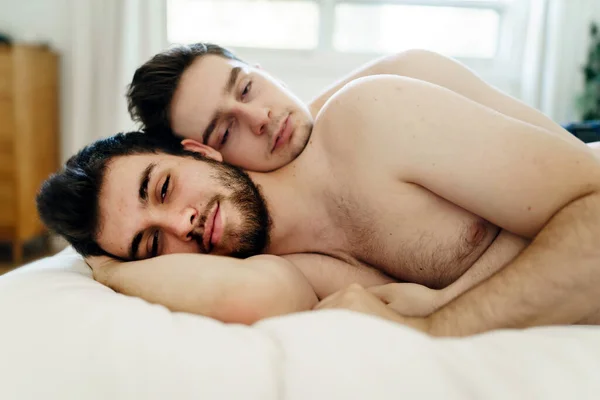 Homosexual couple under a bed at home — Stockfoto