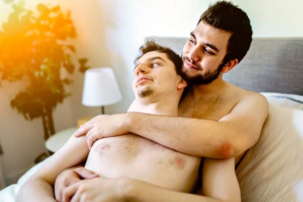 Homosexual couple under a bed at home — Stock Photo, Image