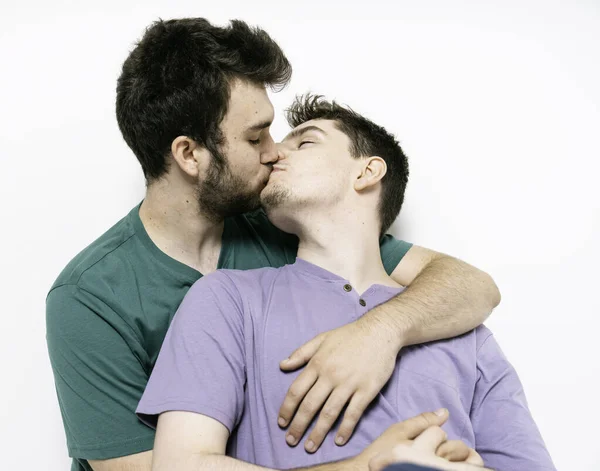 Young gay couple standing together over isolated background giving kiss — 스톡 사진