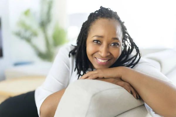Portrait of an african woman sit on the sofa — Stok fotoğraf