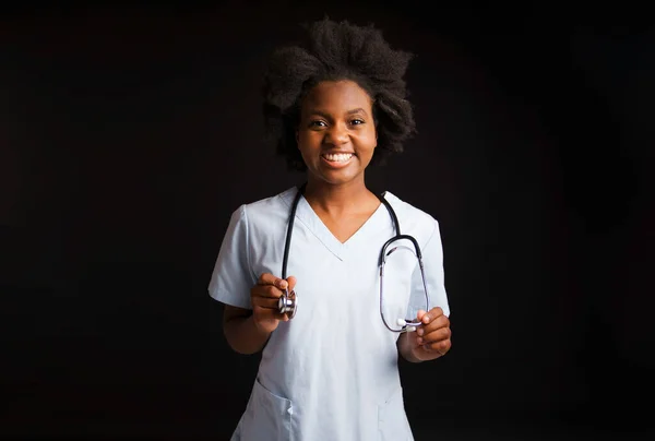 Portrait of afro american female nurse on black background — Stockfoto