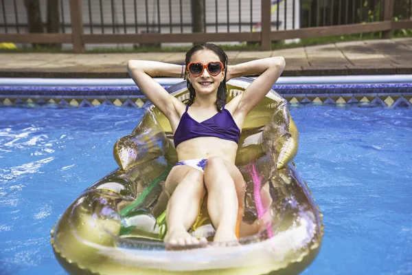 Child girl relax in Pool on the summer time with sun glasses — Stok fotoğraf