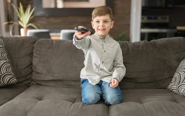 Boy watching television sit on the sofa at home — Stock Photo, Image