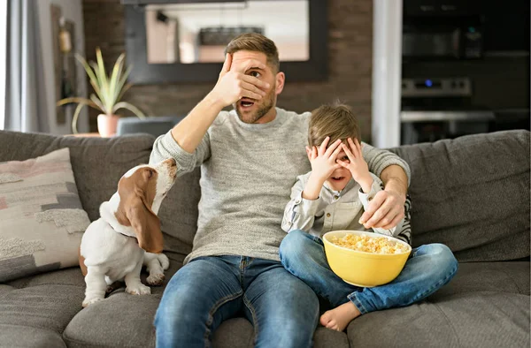 Father or Godfather with Basset dog having fun on the living room At Home watching movie with popcorn look like afraid — Stock Photo, Image