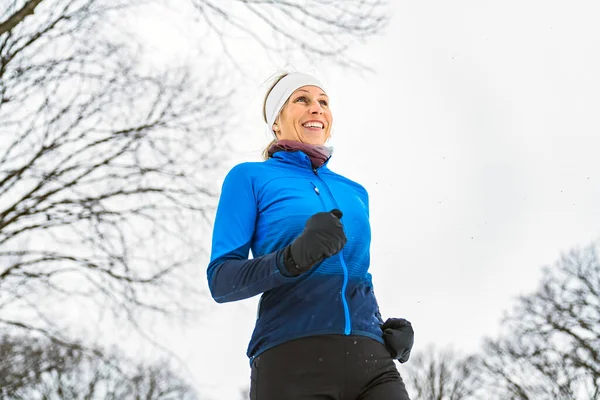 Nice Young Woman Running in Snowy Park —  Fotos de Stock