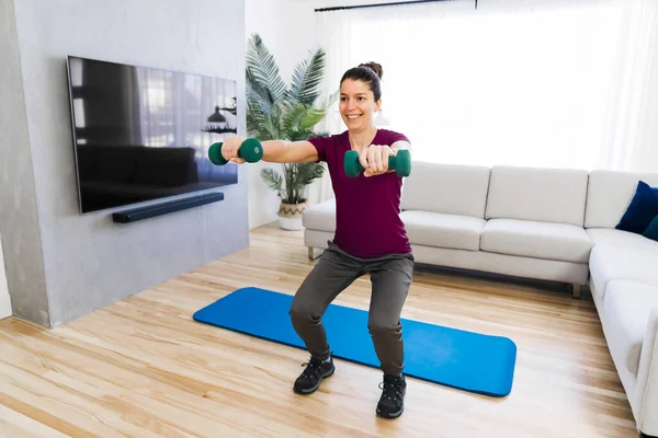 Attractive Fit woman Exercise at home on the living room with dumbell on hand — ストック写真