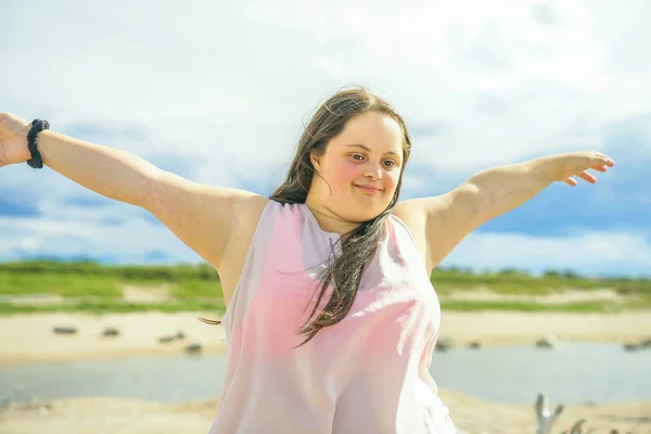 Trisomy 21 woman having fun at the beach — Stok fotoğraf
