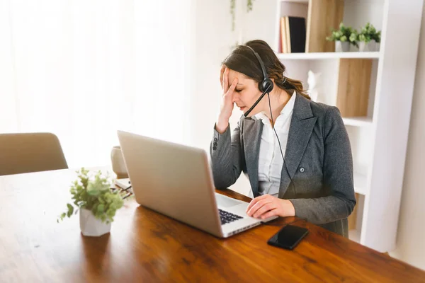 Frustrated and sad woman working on laptop at home — Stock Fotó