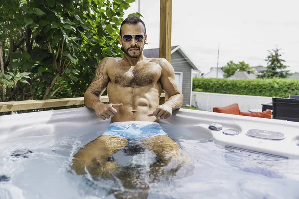 Sexy mexican man relaxing in hot tub on summer season — Zdjęcie stockowe