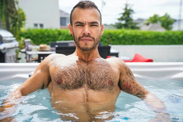 Sexy mexican man relaxing in hot tub on summer season — 스톡 사진