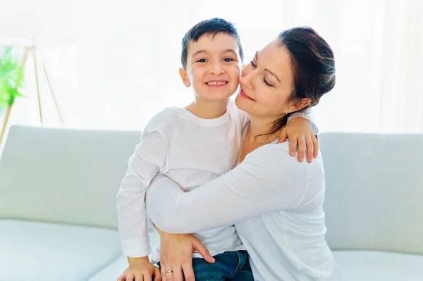 Mother with her son having fun in living room at home — стокове фото
