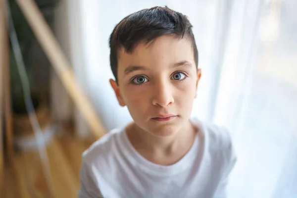 Kid on the living room at home close to a window — Foto Stock