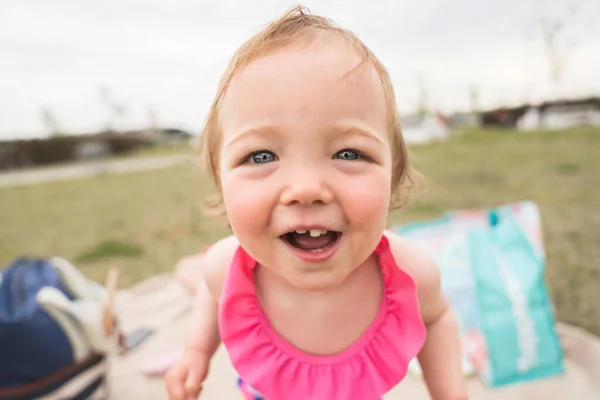 Cute baby girl playing on outdoor playground — Stok fotoğraf