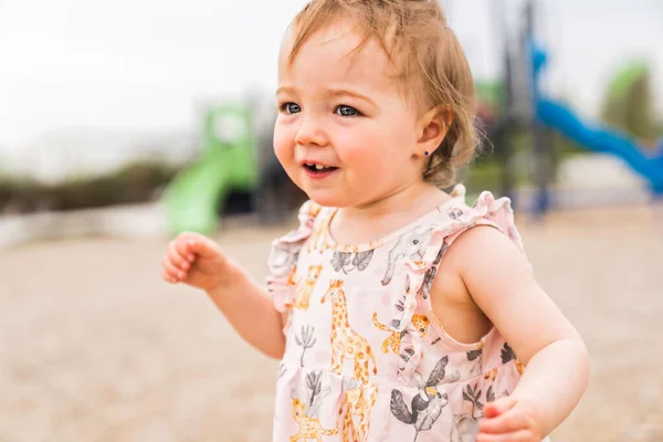 Cute baby girl playing on outdoor playground — Stock fotografie