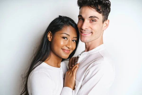 Young couple standing together posing in studio white background — Photo