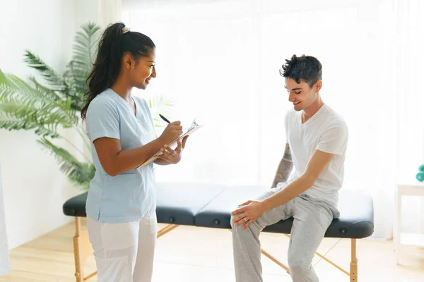 Black rehabilitation woman physiotherapy at physio clinic with customer — Stockfoto