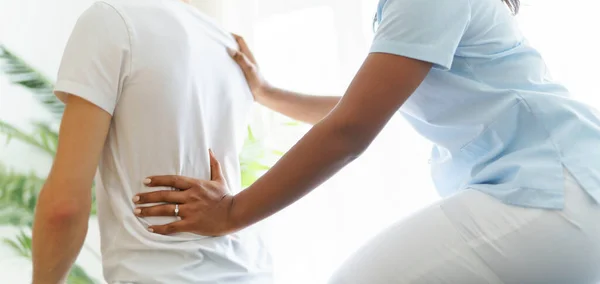 Black rehabilitation woman physiotherapy at physio clinic with customer — Stok fotoğraf