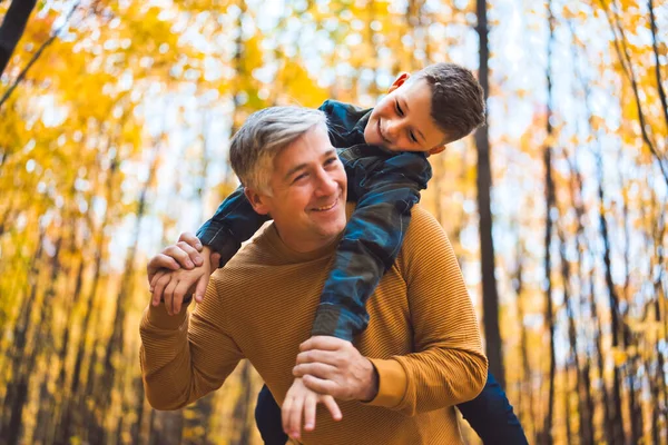Father and daughter having fun in the autumn colorful forest — Stockfoto