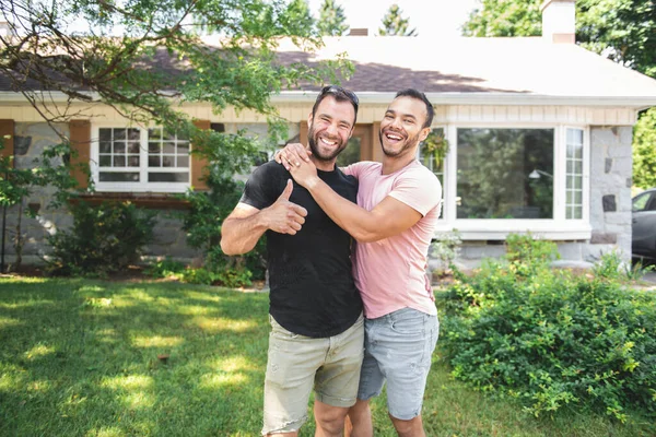 A Portrait of a happy gay couple outdoors in front of a new buy — Foto de Stock