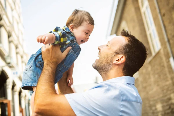 Little baby son with father in city hagging and smiling, casual look outside — Photo